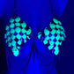 metal scale bra with glowing green and silver scales and hanging chains under blue lighting, edgy and bold