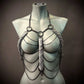 metal chain body jewelry with silver scale details on mannequin, edgy and bold fashion statement