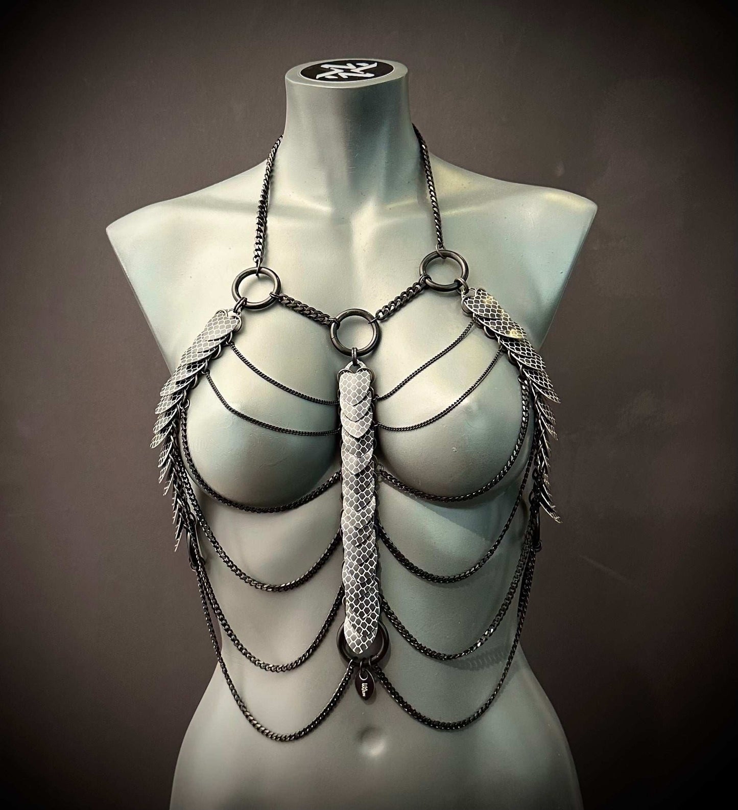 metal chain body jewelry with silver scale details on mannequin, edgy and bold fashion statement
