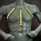 Gold chain body harness with metallic scales on gray mannequin, edgy and bold style