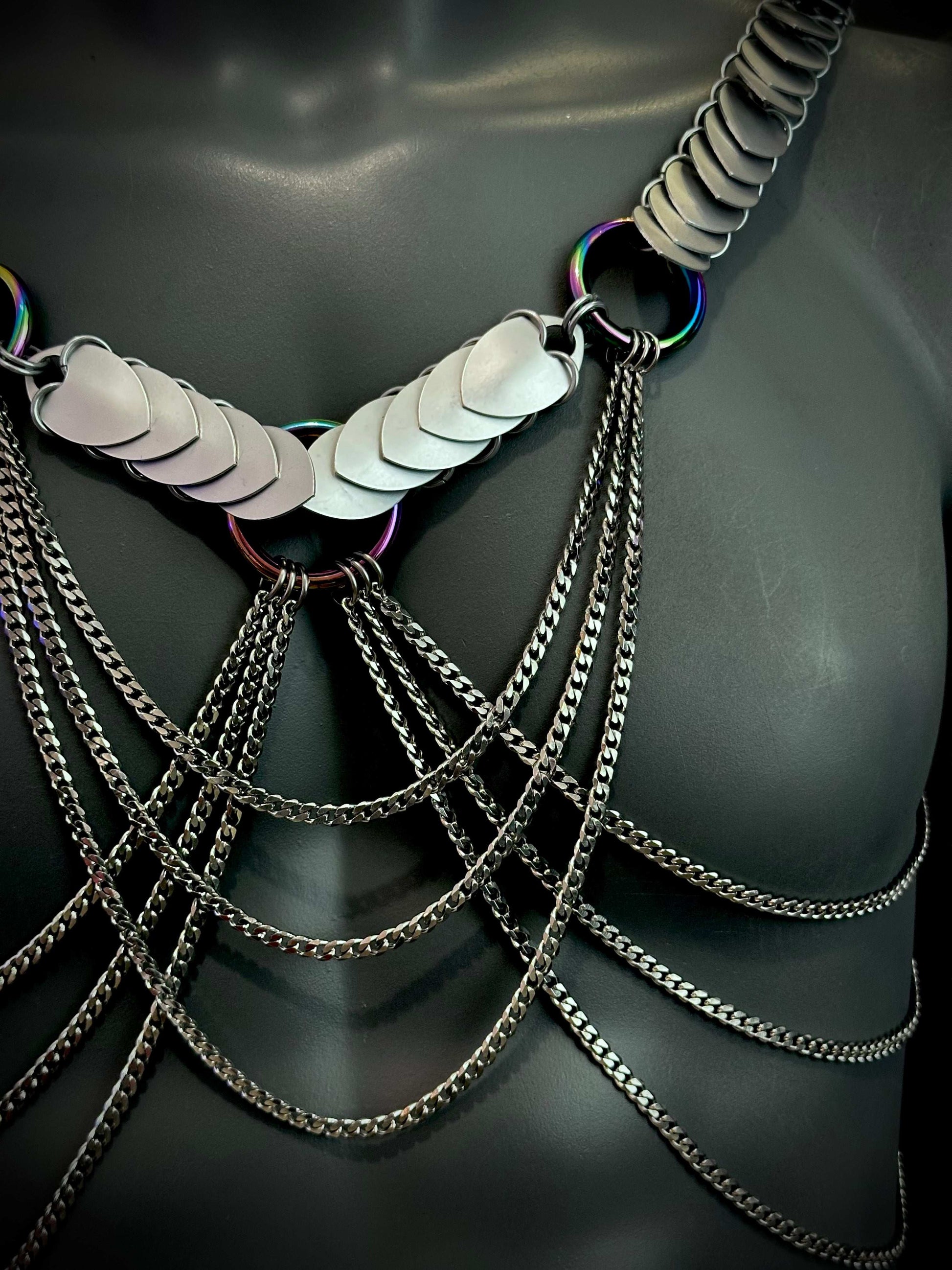 metal body chain harness with silver heart scales and dark metallic chains, edgy and bold fashion statement