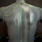 gold chain jewelry draped on matte gray mannequin back, elegant and stylish