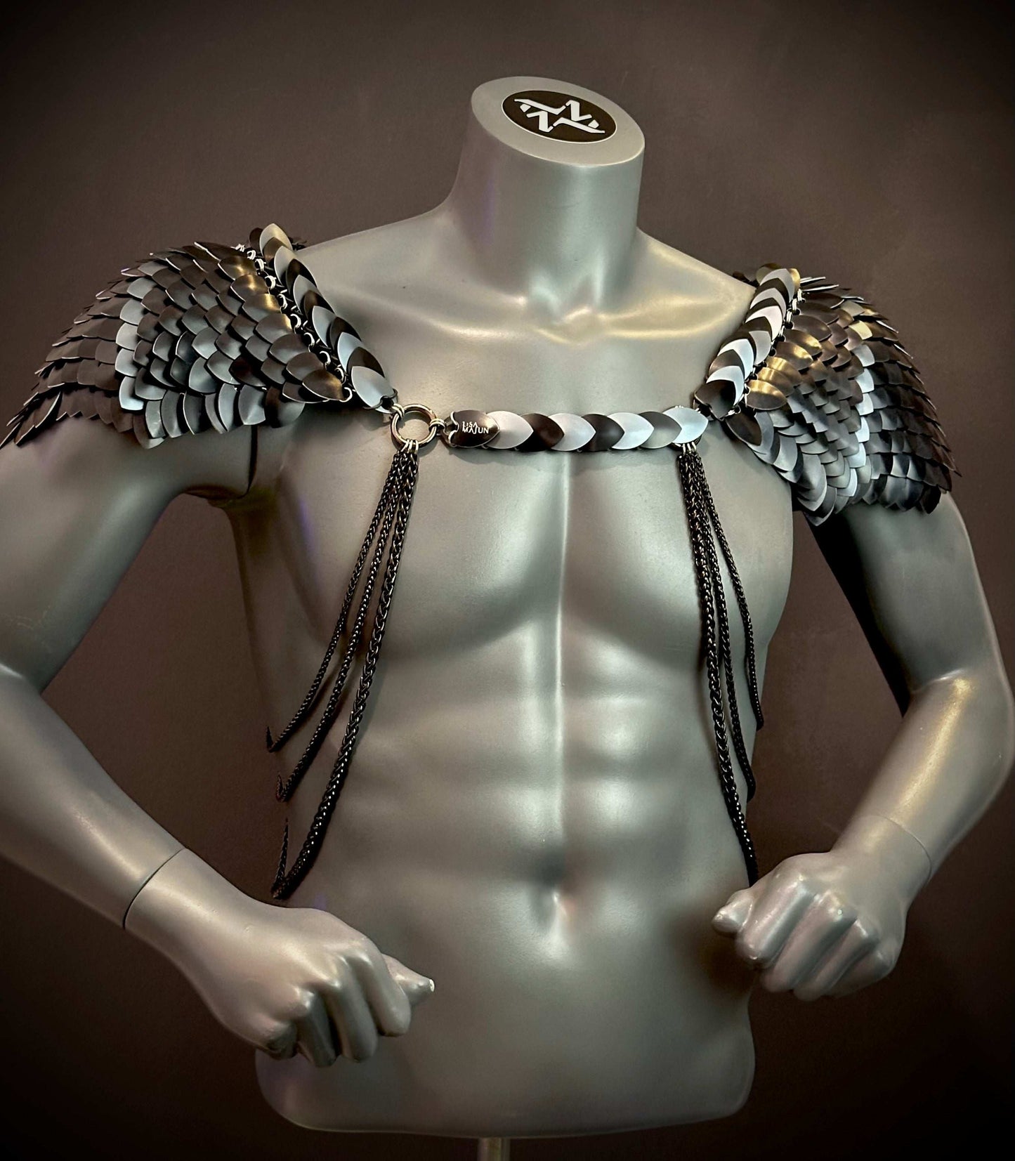 metal scale shoulder armor in black and silver with chains, futuristic style, bold and fierce