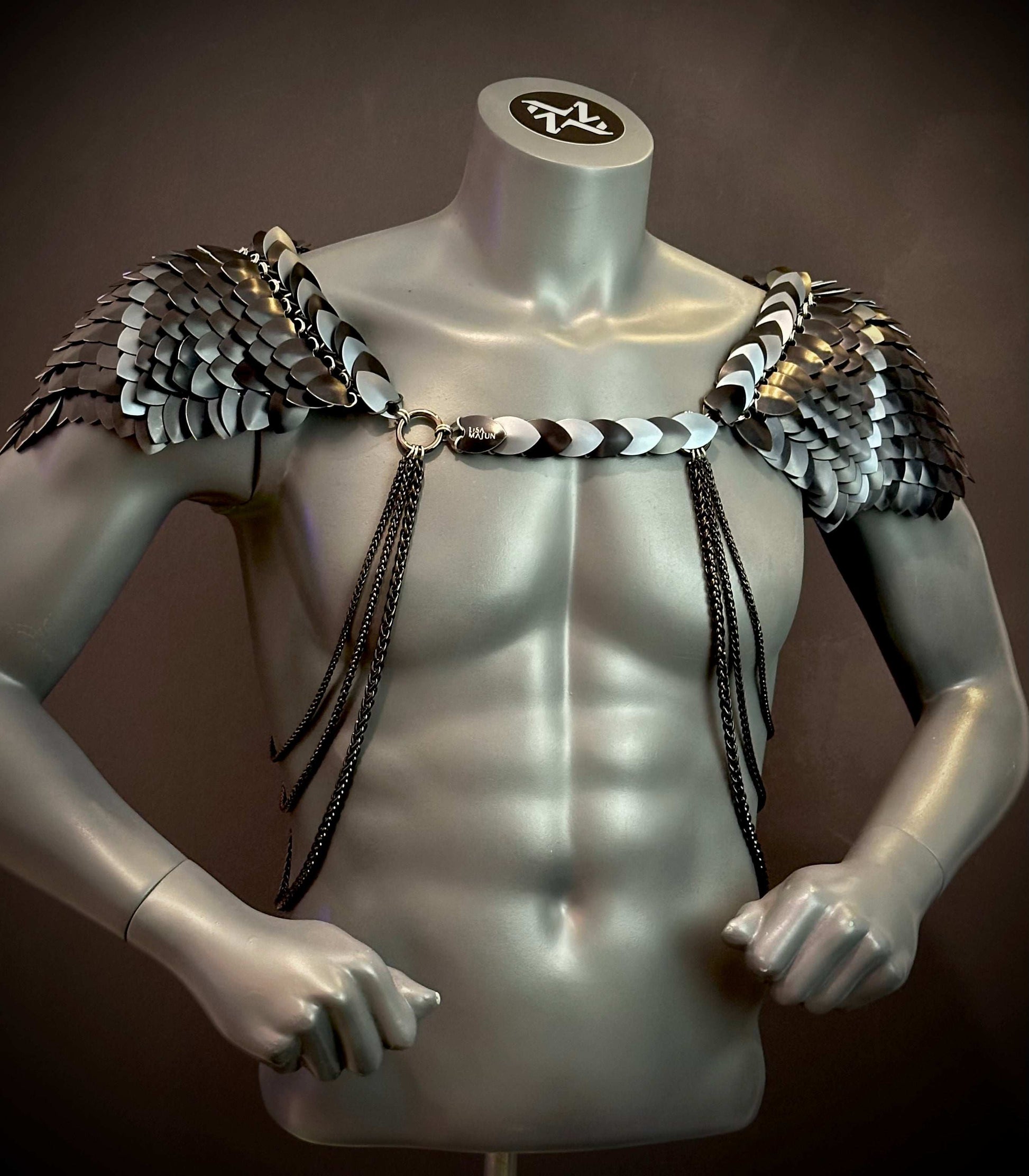 metal scale shoulder armor in black and silver with chains, futuristic style, bold and fierce
