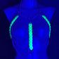 Body harness with neon green glowing scales and silver chains on blue mannequin, futuristic and edgy vibe