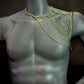 gold chain shoulder jewelry on gray mannequin, stylish and bold, evoking confidence