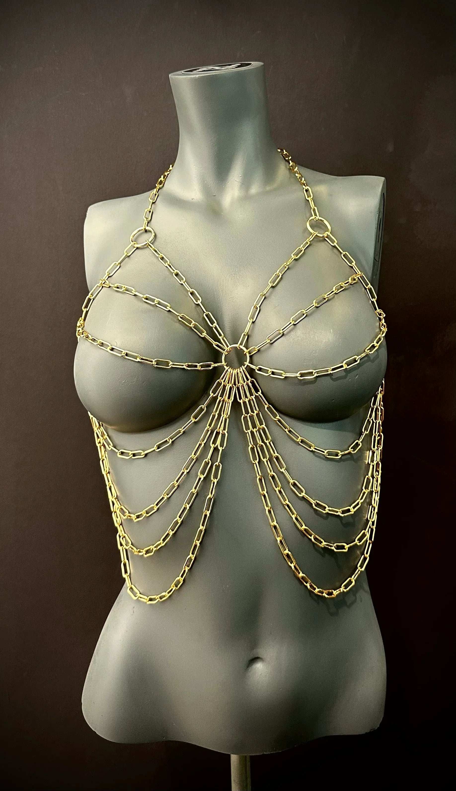 gold chain body jewelry on gray mannequin, stylish and edgy fashion accessory, bold and confident
