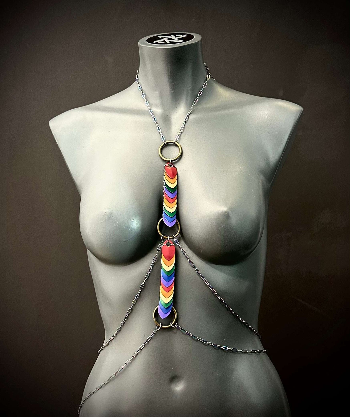 Body chain with rainbow-colored heart charms in silver and brass tones, bold and expressive style