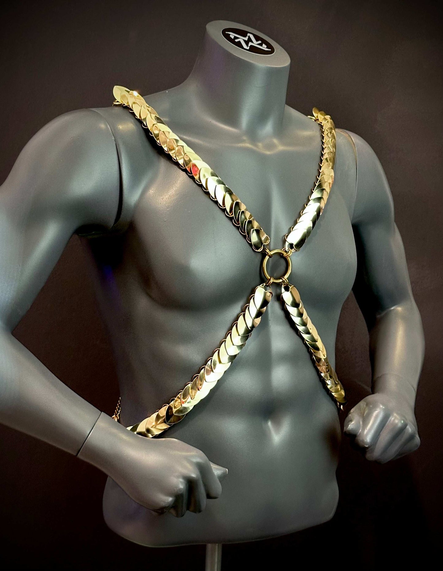 gold chain harness with glossy scale design on gray mannequin torso, bold and stylish