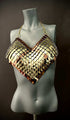 Metallic scale bra top in gold and bronze on a gray mannequin, bold and striking style
