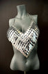 Silver metal scale halter top on gray mannequin, edgy futuristic fashion, bold confident style