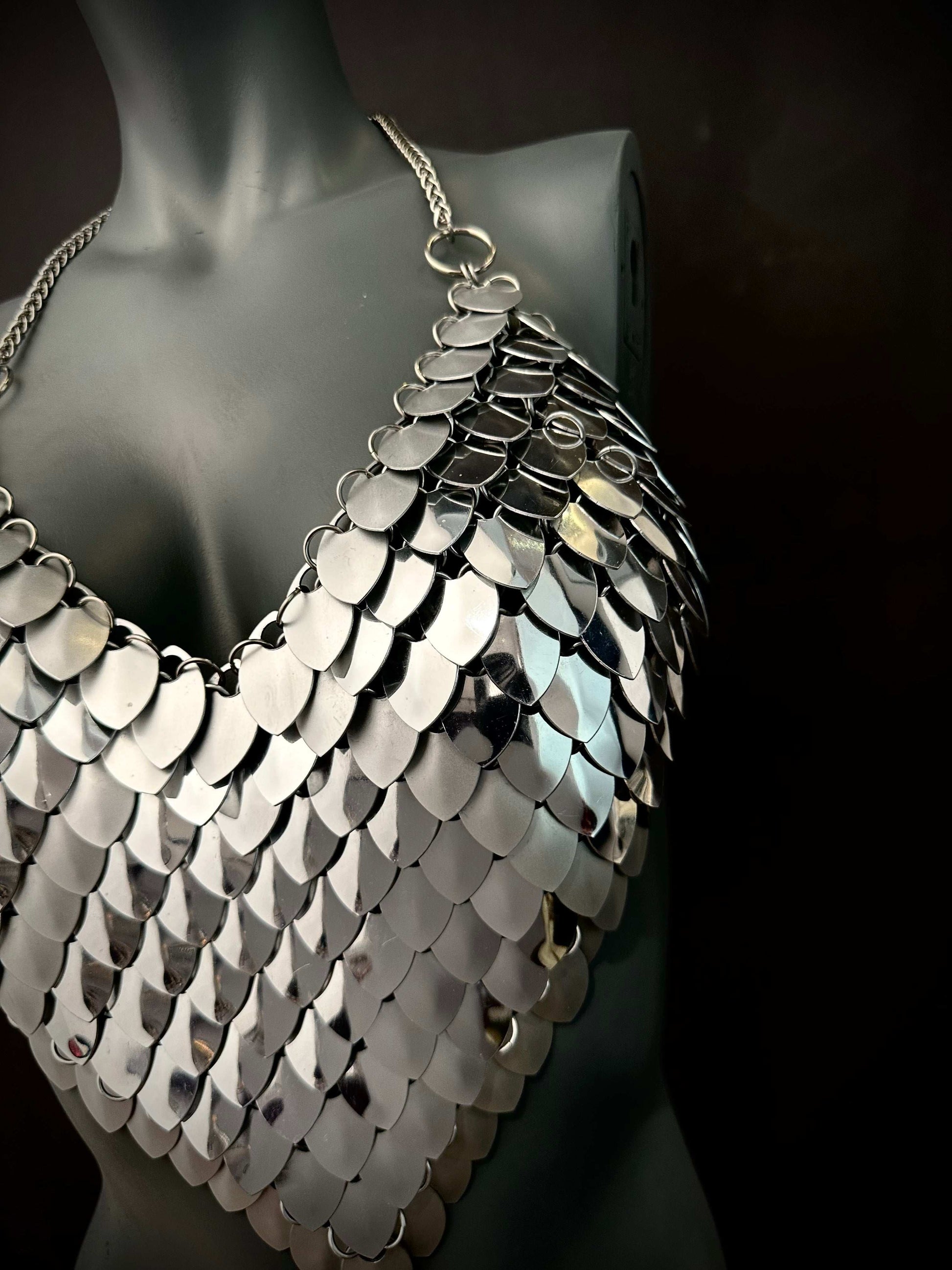 silver metal scale chainmail halter top on black mannequin, edgy and bold fashion