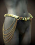 Gold chain belt with pale green scales and dangling chains on black mannequin, edgy and stylish