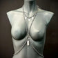 silver body chain jewelry on gray mannequin bust, modern minimalist style, elegant and bold