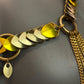 Gold chain necklace with metallic silver and yellow heart-shaped pendants, elegant and stylish