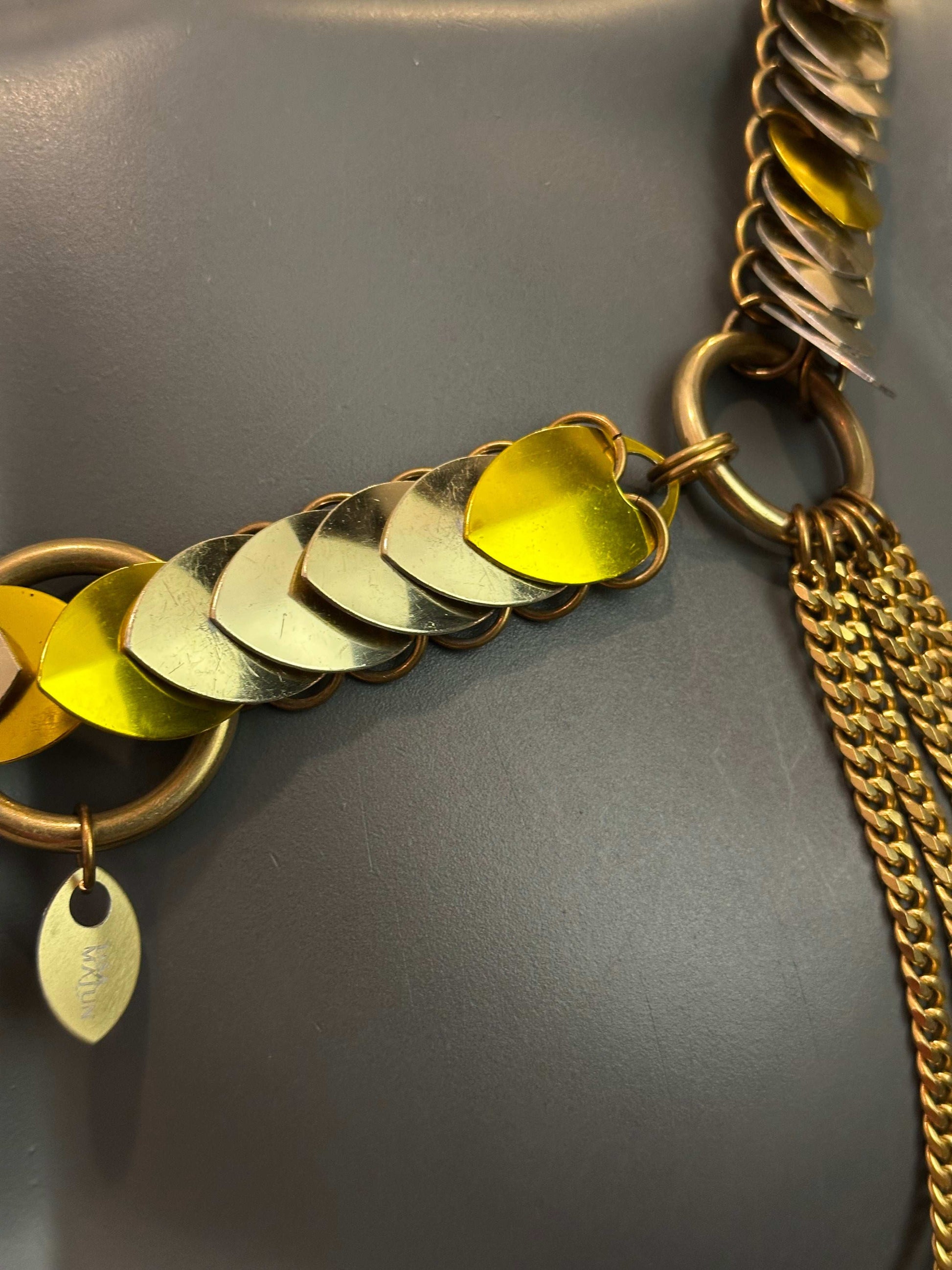 Gold chain necklace with metallic silver and yellow heart-shaped pendants, elegant and stylish