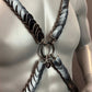 metal chest harness with matte black and grey scale-like plates on a gray mannequin, bold and edgy