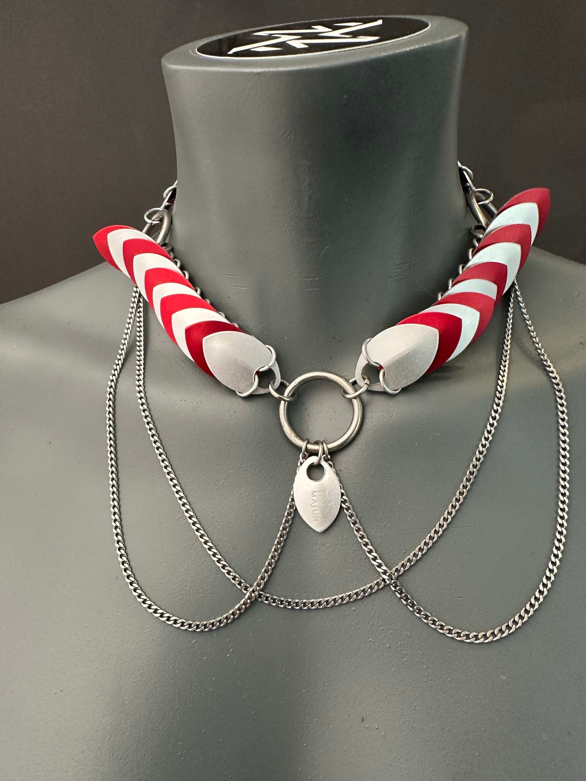 necklace with red and white curved accents and silver chains, modern edgy style, confident vibe