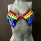 Rainbow scale metal bra with silver chains on gray mannequin, bold and vibrant style, expressive and confident