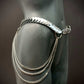 Silver metal hip chain belt with layered chains on black mannequin, edgy and bold style
