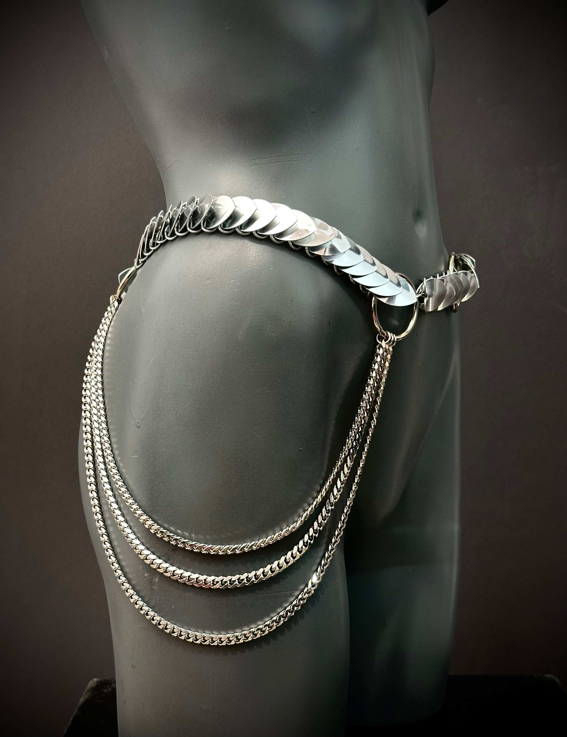 Silver metal hip chain belt with layered chains on black mannequin, edgy and bold style