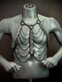 Silver metal chain body harness with black chains and snake scale details, edgy and bold style