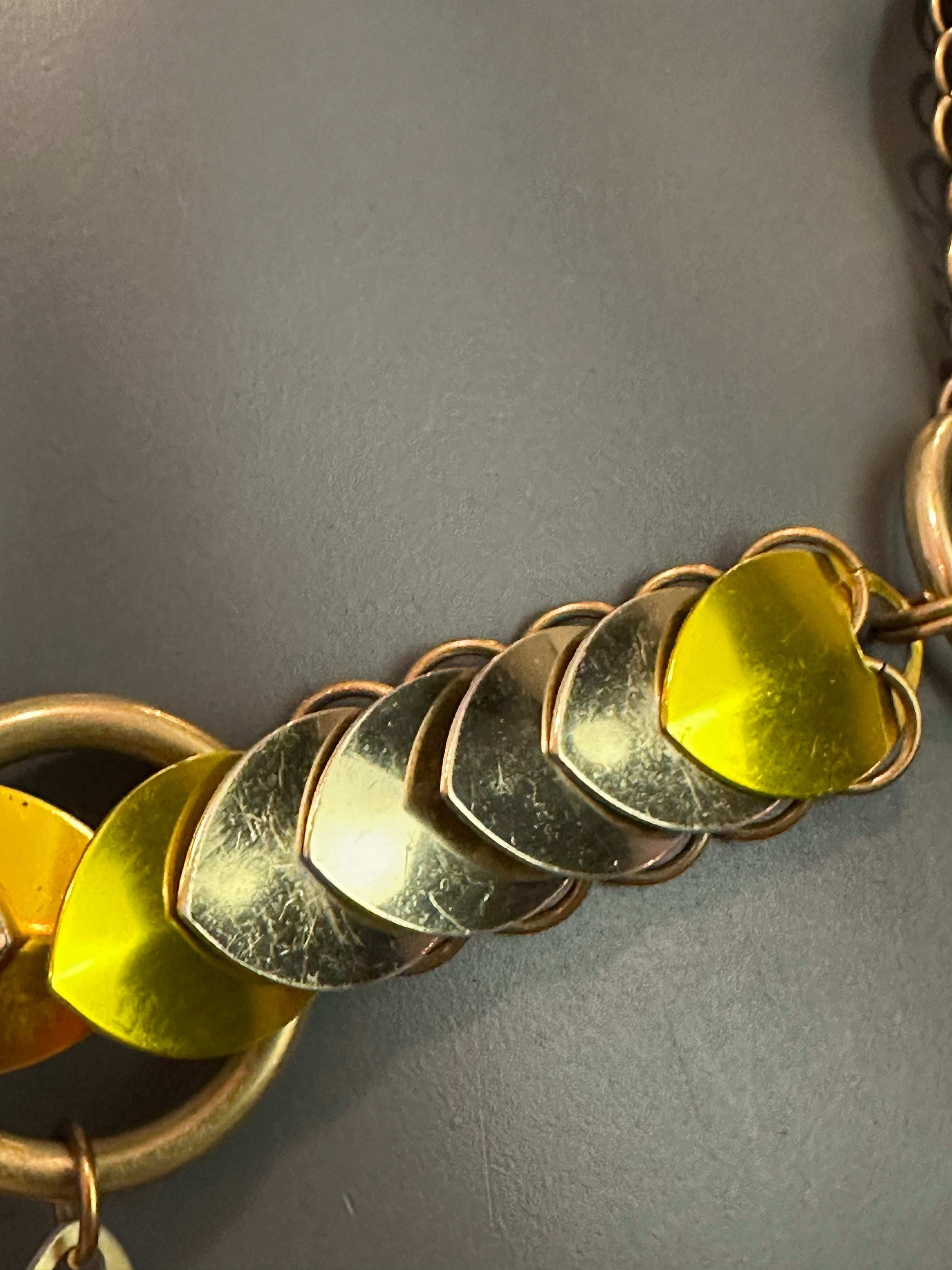 Heart-shaped metal charms in gold and yellow on bracelet chain, vintage style, romantic sentiment