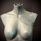 Silver chain necklace with layered design draped on gray mannequin, modern and edgy style