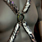 Metal chain harness with silver scales and rainbow ring on dark mannequin, bold and edgy fashion