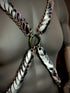 Metal chain harness with silver scales and rainbow ring on dark mannequin, bold and edgy fashion