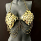 Gold metal scale bra with chain details on black mannequin, bold and glamorous fashion