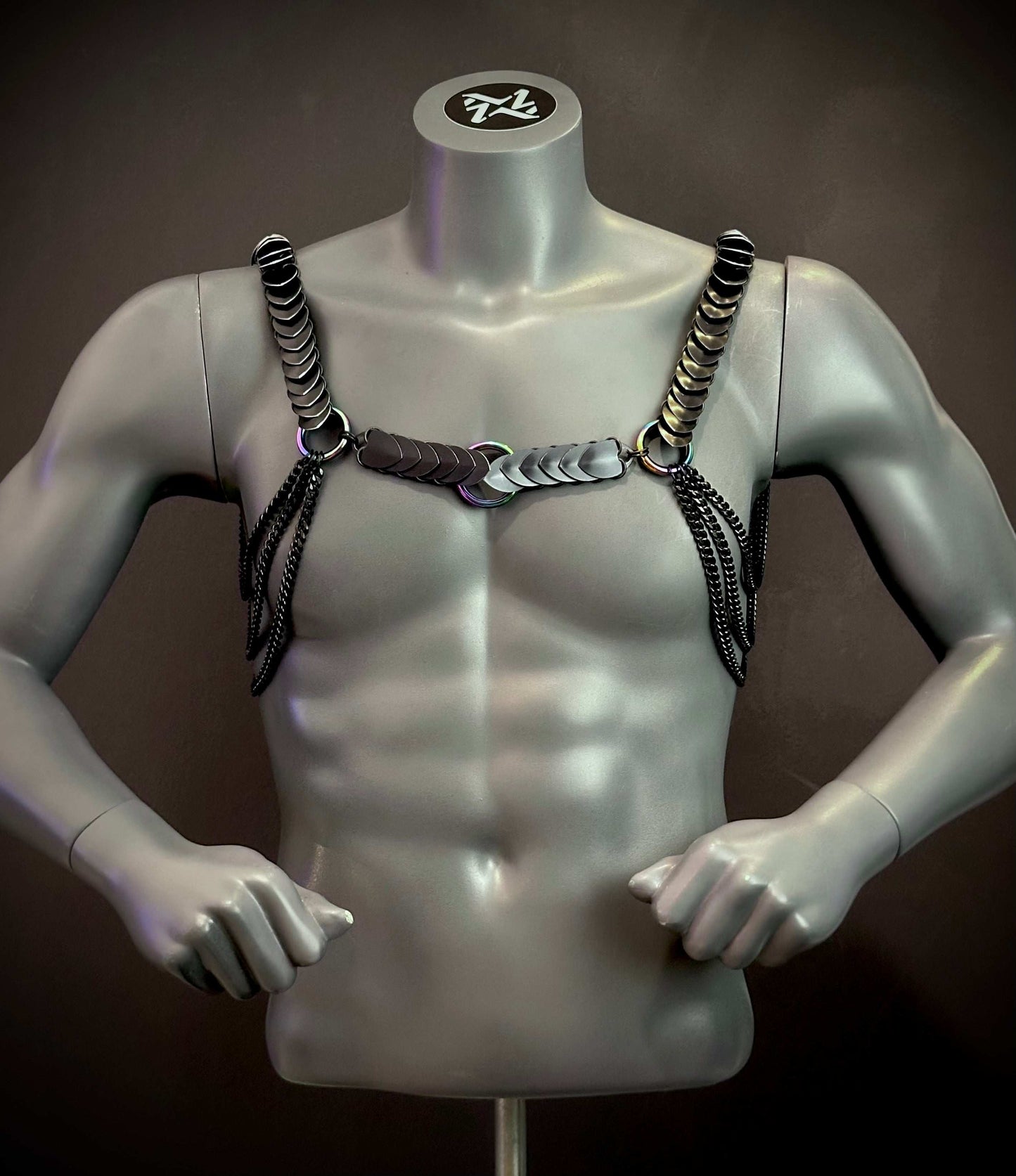 Silver mannequin wearing black metallic chain harness with sleek, edgy style, creating bold, confident vibe