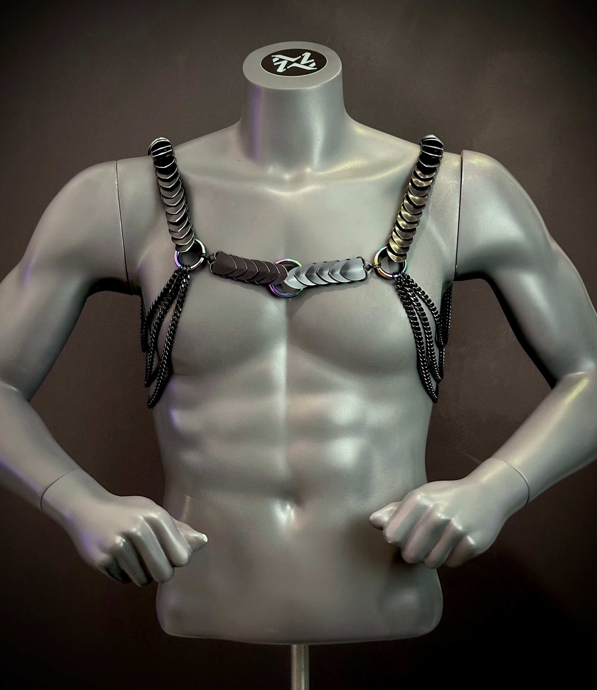 Silver mannequin wearing black metallic chain harness with sleek, edgy style, creating bold, confident vibe