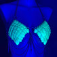 Chain bra with turquoise scales and metal chains, glowing under blue light, evoking edgy allure