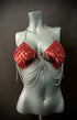 Red scale chainmail bikini top with silver chains on grey mannequin, edgy and bold fashion