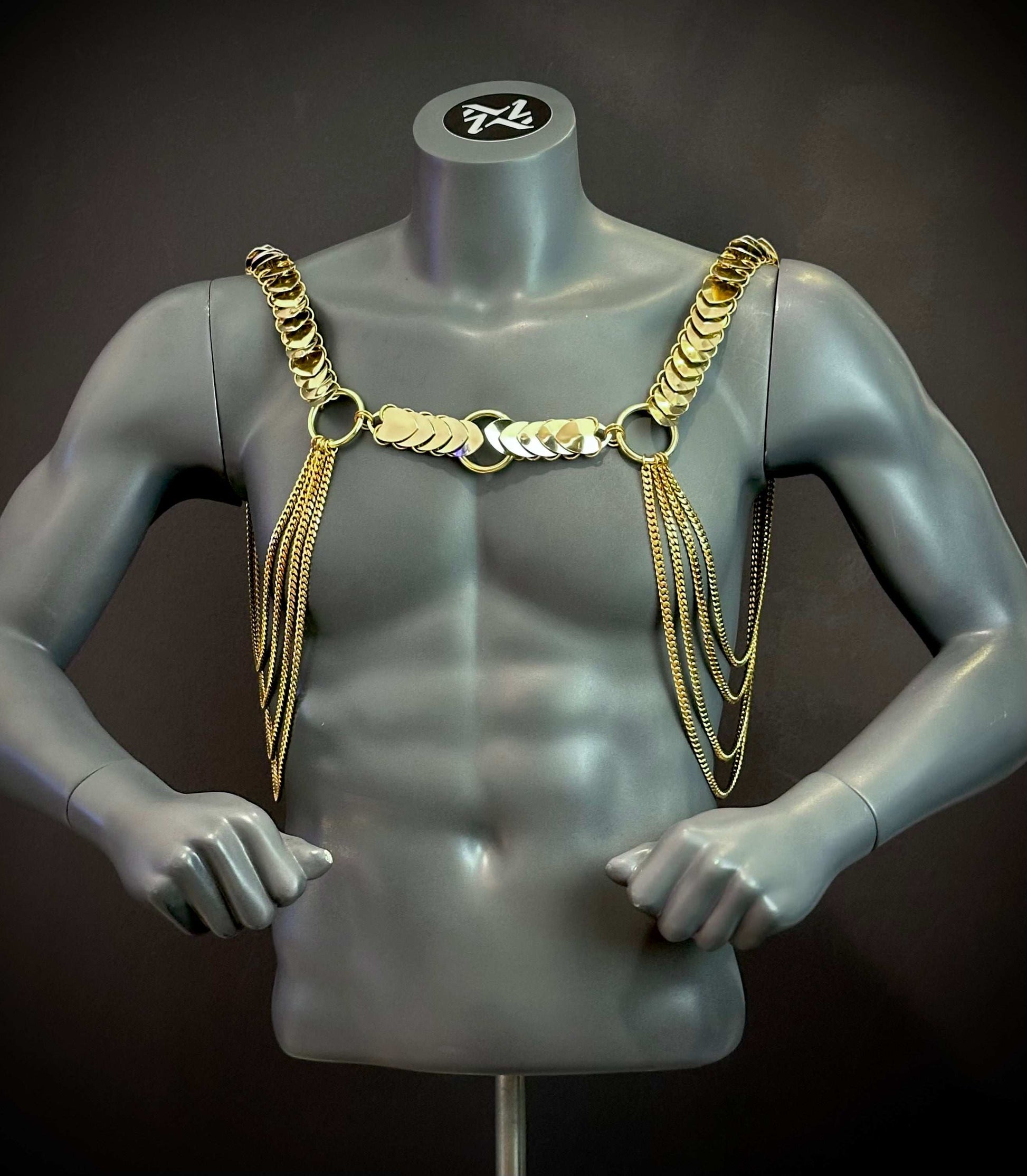 Gold chain body harness on gray mannequin, stylish edgy accessory, bold confident fashion