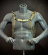 Gold chain body harness on gray mannequin, stylish edgy accessory, bold confident fashion