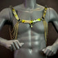 gold metal chain harness with scale-like plates on gray mannequin conveying bold style