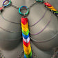 rainbow-colored chain harness with layered heart links and iridescent metal rings, bold and expressive
