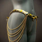 Gold chain belt with layered links and chains on gray mannequin, elegant and bold fashion