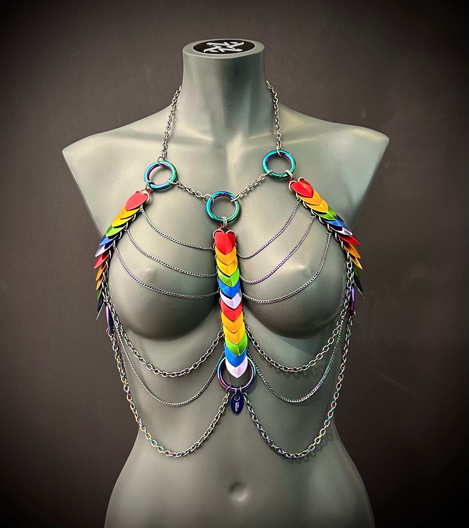 Rainbow chain body harness with metal rings and colorful scales, bold and vibrant style, expressive and playful