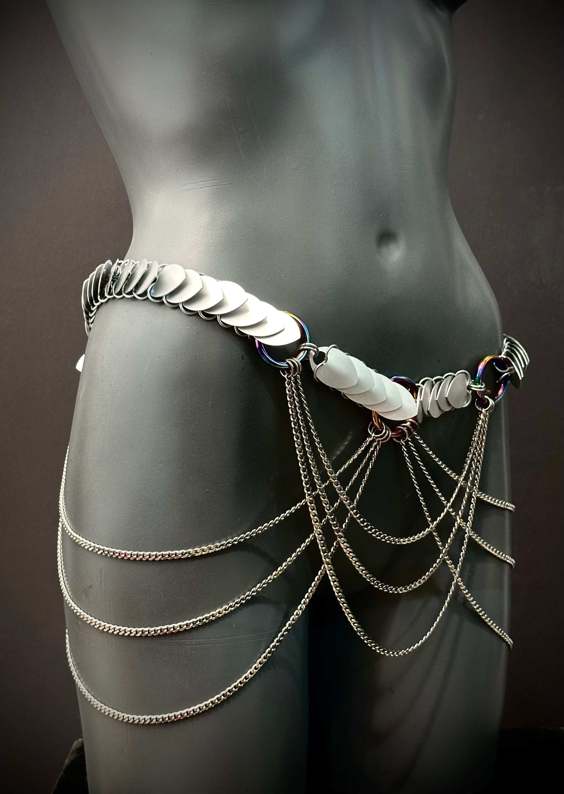 Body chain accessory silver metal scales with cascading chains on gray mannequin, edgy and bold