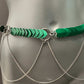 green heart-shaped scale chain belt with silver rings and draped silver chains on gray mannequin for edgy style