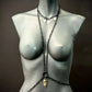 black metal body chain with gold pendants on gray mannequin, stylish and edgy