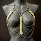 metal body chain harness in silver with translucent leaf accents on black mannequin, edgy and bold fashion