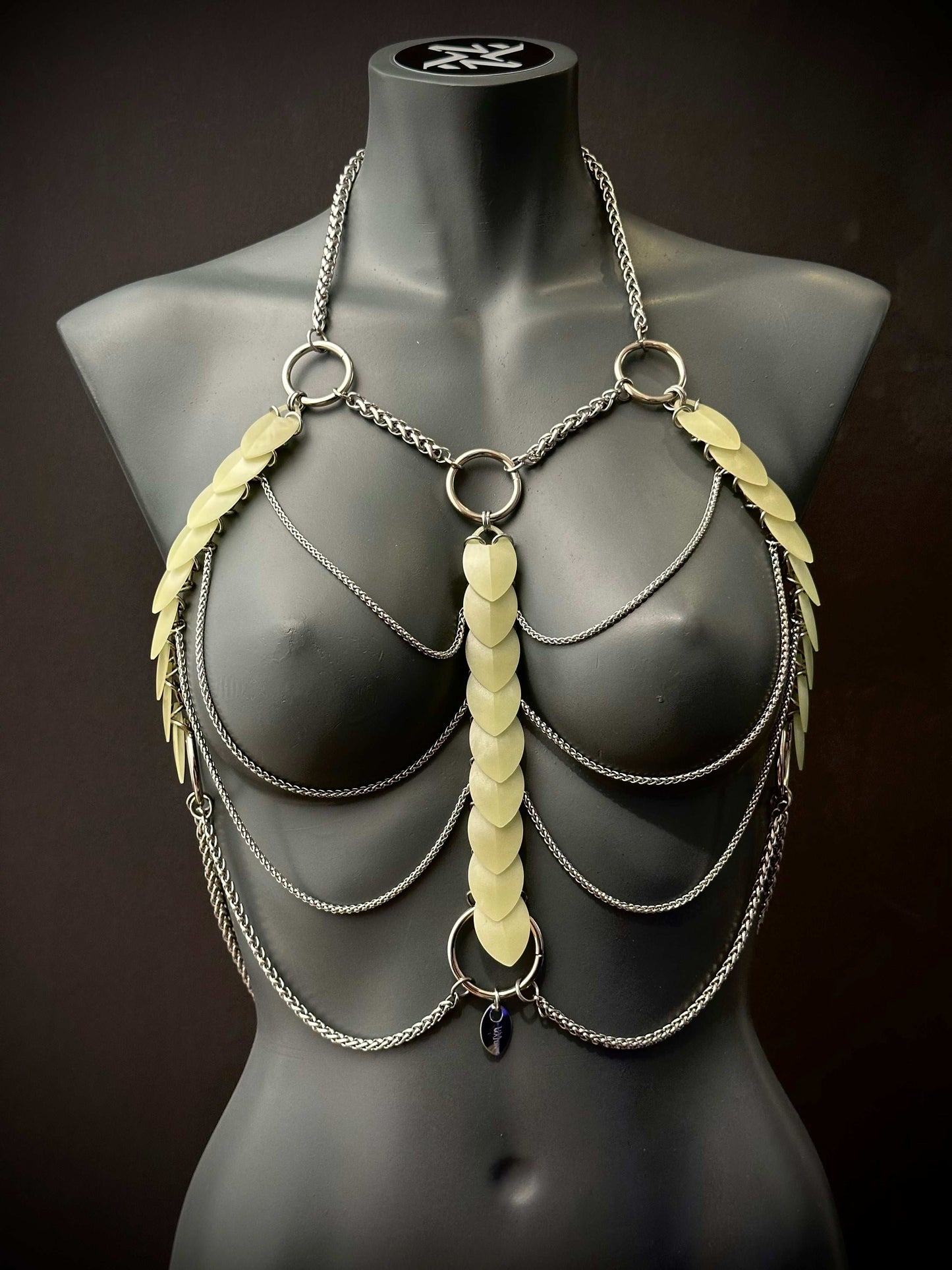 metal body chain harness in silver with translucent leaf accents on black mannequin, edgy and bold fashion