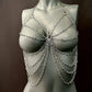 Silver metal chain body harness on gray mannequin, edgy style, bold and confident vibe