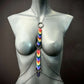 Rainbow heart chain body harness on gray mannequin, colorful and vibrant style, bold and expressive