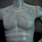 silver metal chain body harness on gray mannequin torso, stylish and bold fashion accessory