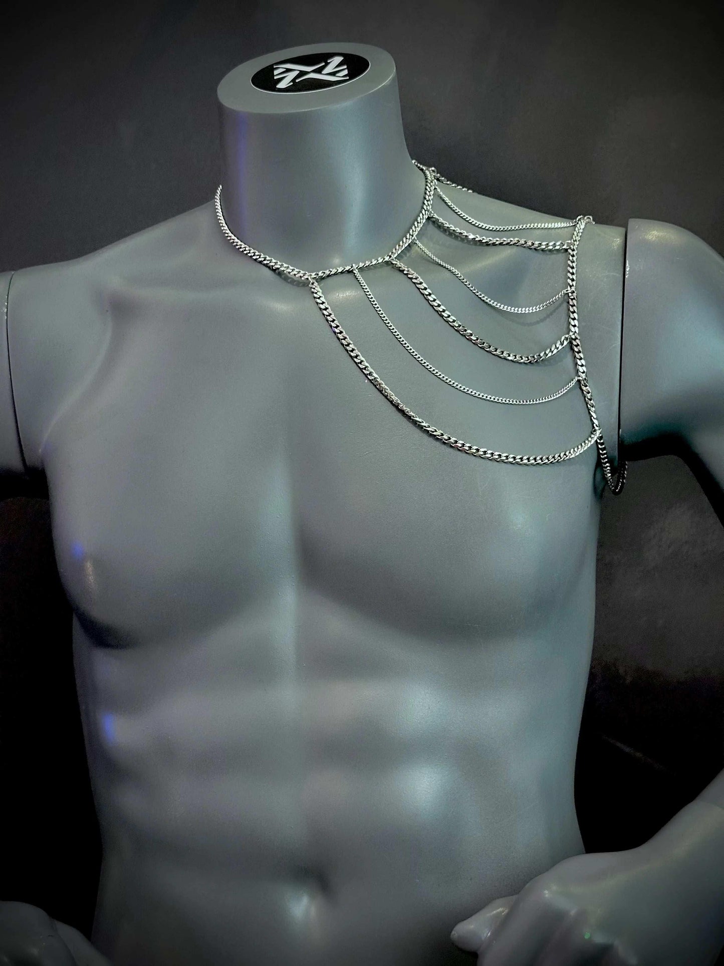 silver metal chain body harness on gray mannequin torso, stylish and bold fashion accessory